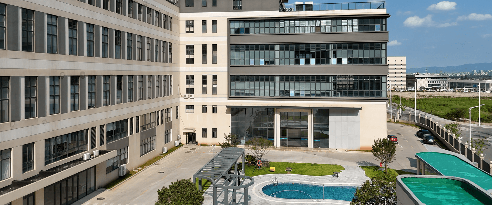 Modern building complex with solar panels and swimming pool