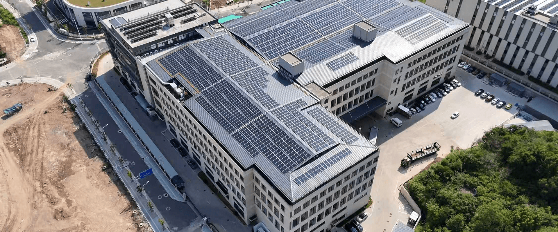 Modern building complex with solar panels and green spaces