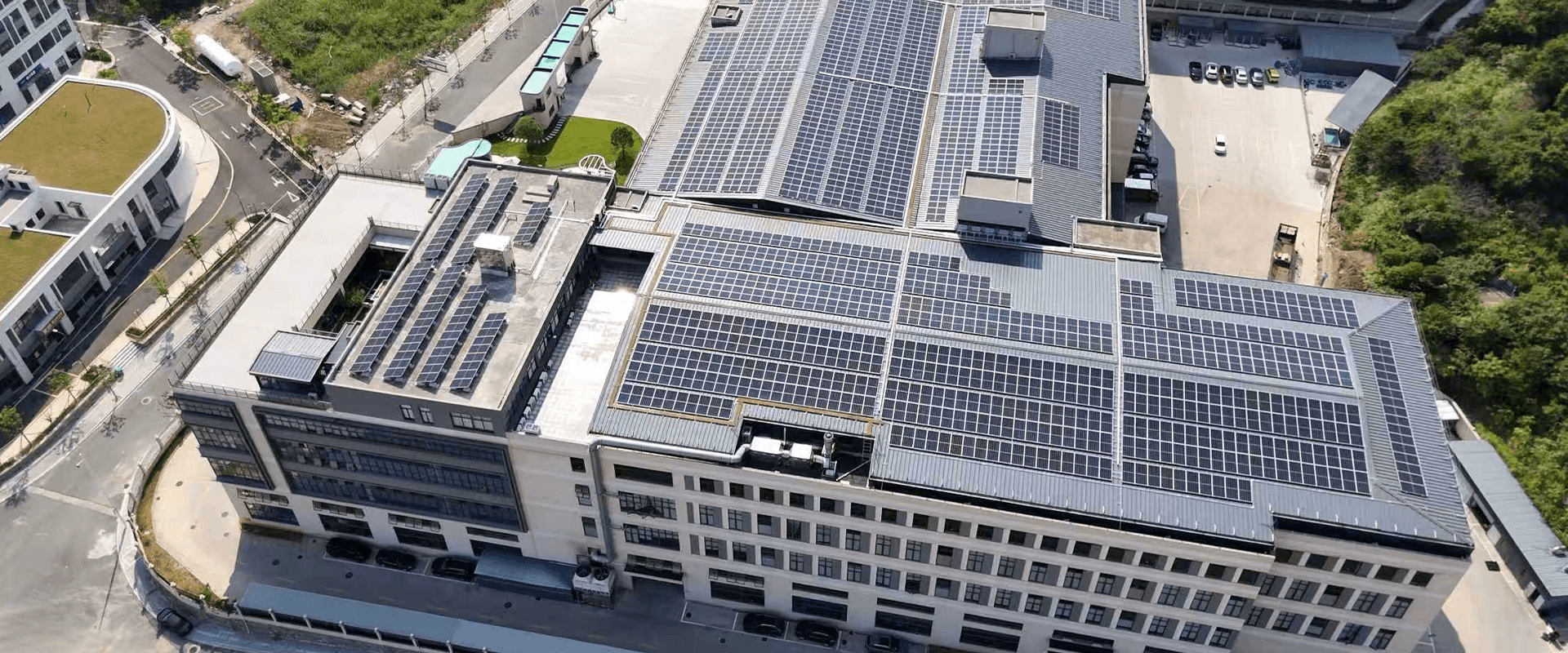 Modern industrial facility with extensive solar panel coverage